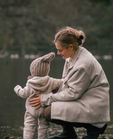 Stimmungsvolles Familienfoto in Kiel: Mutter und Tochter verbringen gemeinsam Zeit am Seeufer im natürlichen Licht